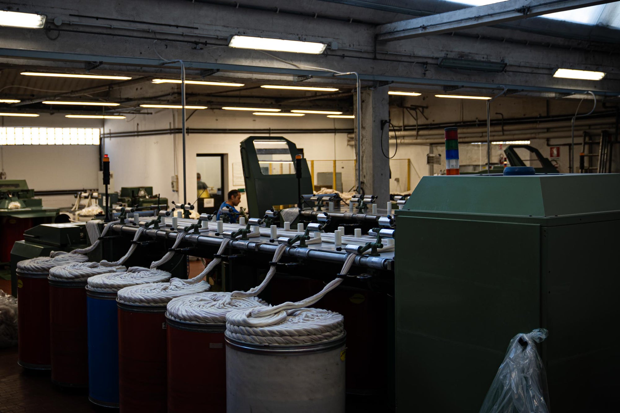 A wide shot of Merino wool and cashmere tops being fed into the combing machine at the ARA facility.