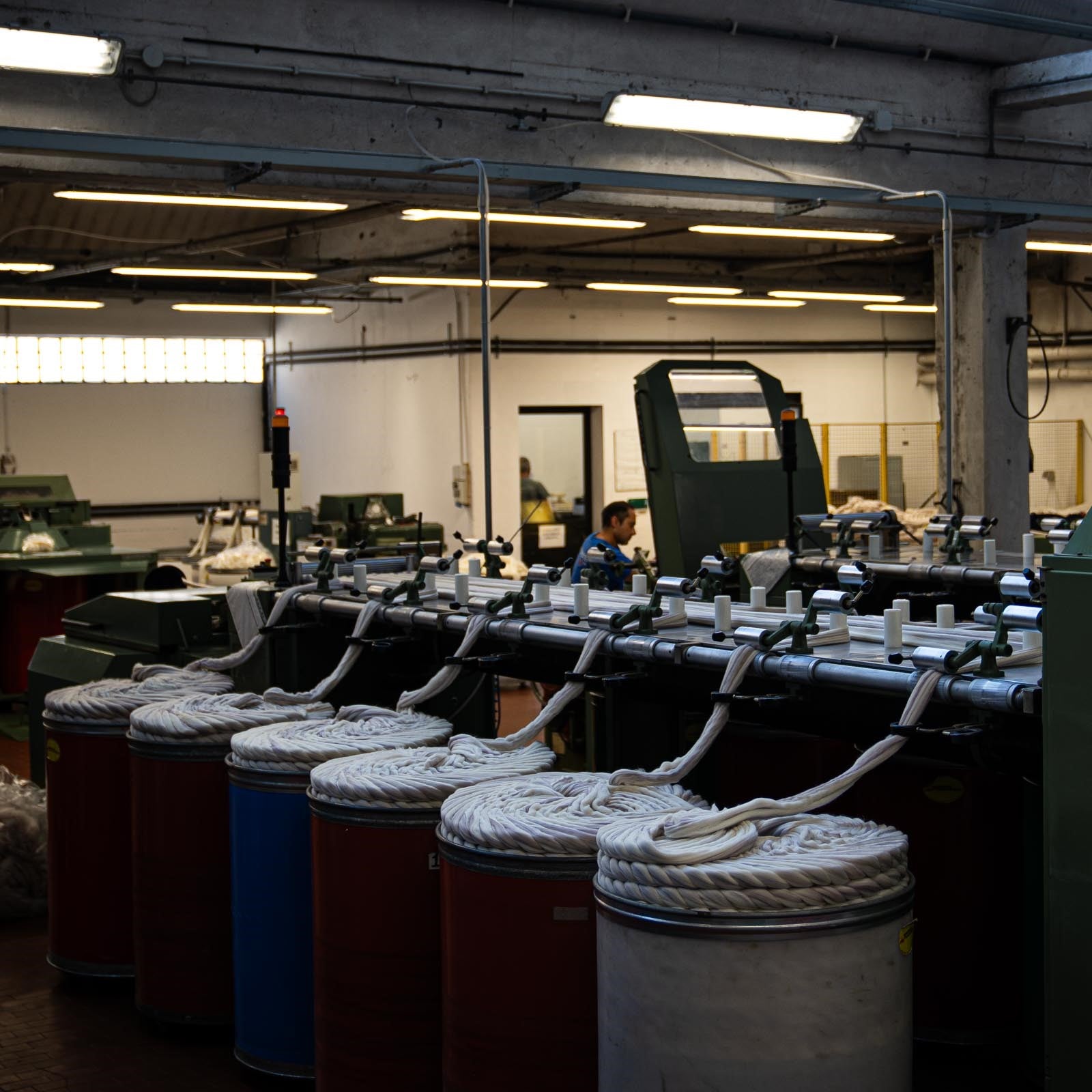 A wide shot of Merino wool tops being fed into the wool blending and combing machine at the ARA spinning facility.