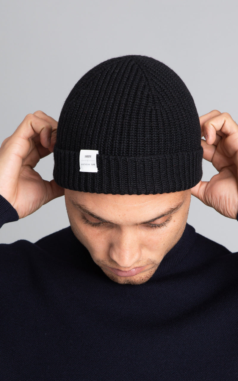 Front profile of model wearing The Merino Beanie in navy