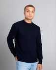 Model wearing The Merino Jacquard 2.0 Navy, front view - Unborn