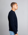 Model wearing The Merino Jacquard 2.0 Navy, right view - Unborn