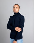 Model wearing The Merino Roll Neck Sweater Navy, front view - Unborn