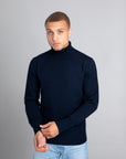 Model wearing The Merino Roll Neck Sweater Navy, front view - Unborn