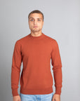Model wearing The Merino Sweater lightweight Burnt Orange, front view - Unborn