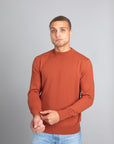 Model wearing The Merino Sweater lightweight Burnt Orange, front view - Unborn