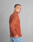 Model wearing The Merino Sweater lightweight Burnt Orange, right view - Unborn