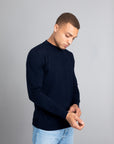 Model wearing The Merino Sweater lightweight Navy, front view - Unborn