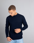 Model wearing The Merino Sweater lightweight Navy, front view - Unborn