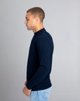 Model wearing The Merino Sweater lightweight Navy, left view - Unborn
