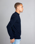 Model wearing The Merino Sweater lightweight Navy, right view - Unborn