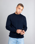 Model wearing The Merino sweater Navy, front view - Unborn