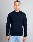 Model wearing The Merino sweater Navy, front view - Unborn