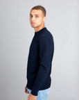 Model wearing The Merino sweater Navy, left view - Unborn