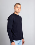 Model wearing The Merino sweater Navy, right view - Unborn