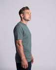 Model wearing Merino Featherweight T-shirt Moss Green Side View