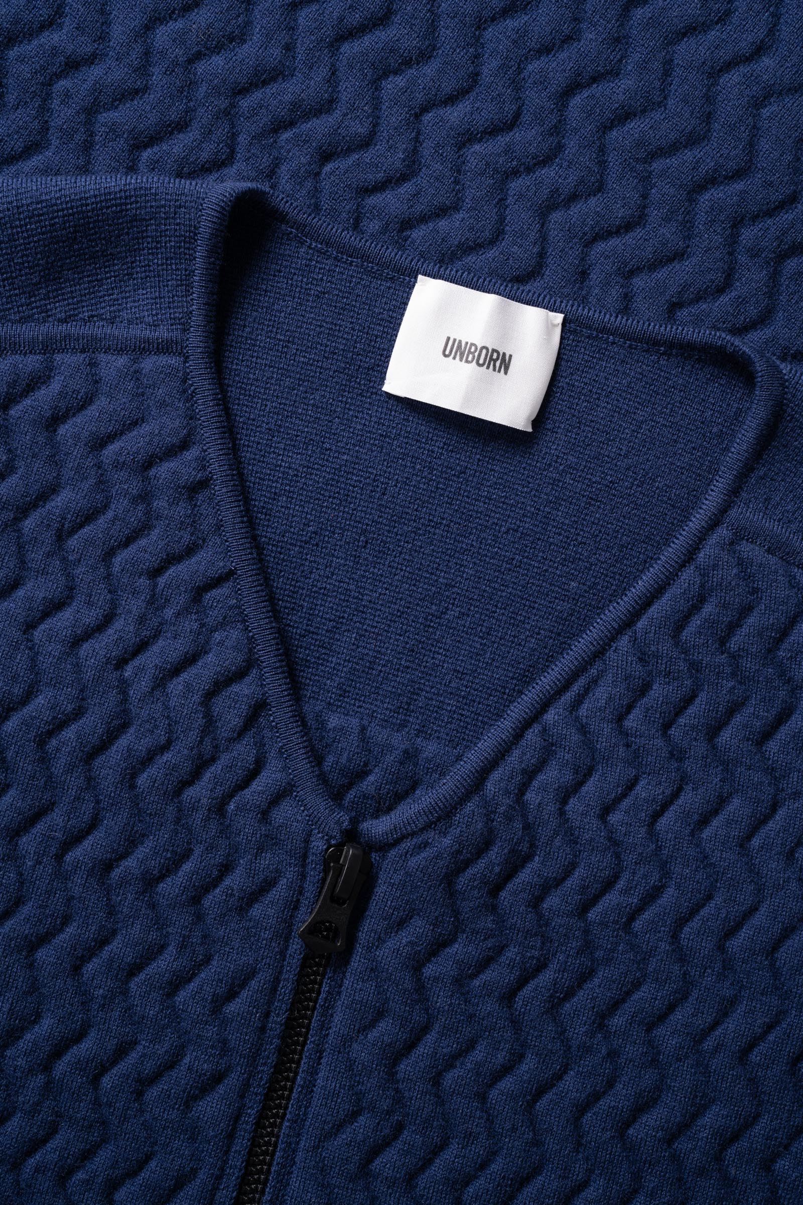 Close up with details of the collar of the UNBORN Merino d&#39;Arles Padded vest in medieval blue