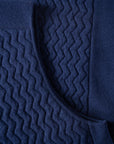 Close up with details of the fully fashioned details of the UNBORN Merino d'Arles Padded vest in medieval blue
