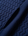 Close up with details of the pockets of the UNBORN Merino d'Arles Padded vest in medieval blue
