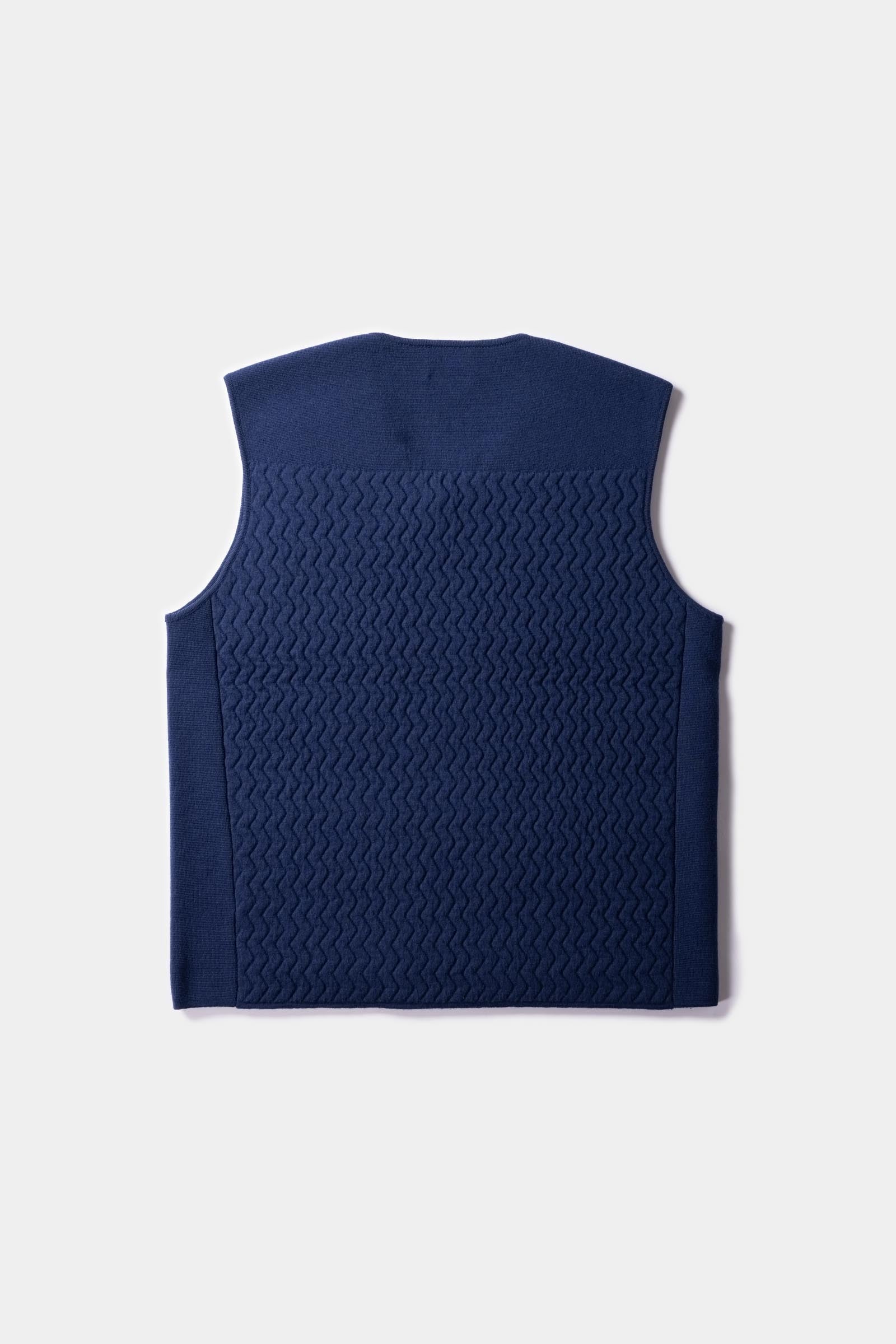 Flatlay of the back side of the UNBORN Merino d&#39;Arles Padded vest in medieval blue