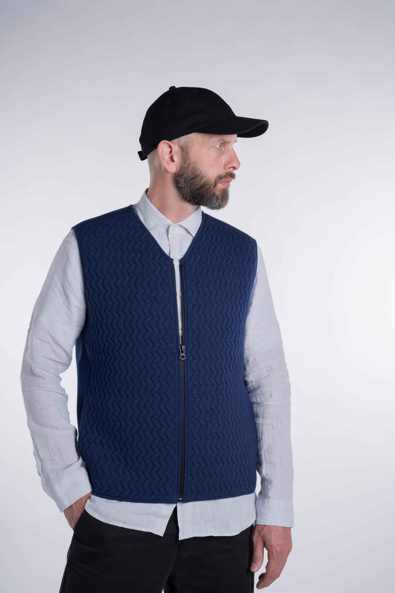 Front view of model wearing the UNBORN Merino d&#39;Arles Padded vest in medieval blue with closed zipper