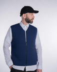 Front view of model wearing the UNBORN Merino d'Arles Padded vest in medieval blue with closed zipper