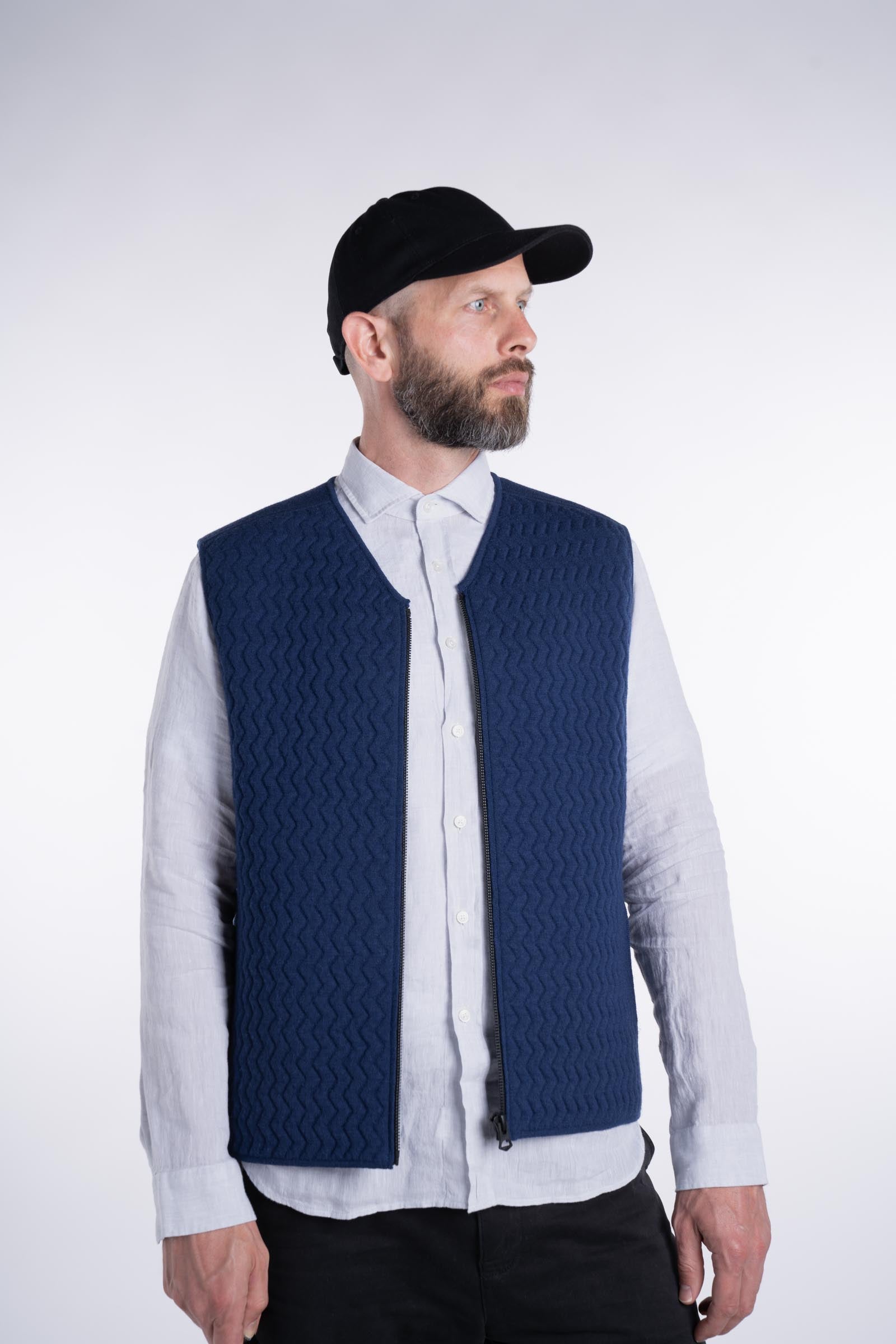 Front view of model wearing the UNBORN Merino d&#39;Arles Padded vest in medieval blue with open zipper