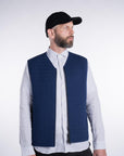 Front view of model wearing the UNBORN Merino d'Arles Padded vest in medieval blue with open zipper
