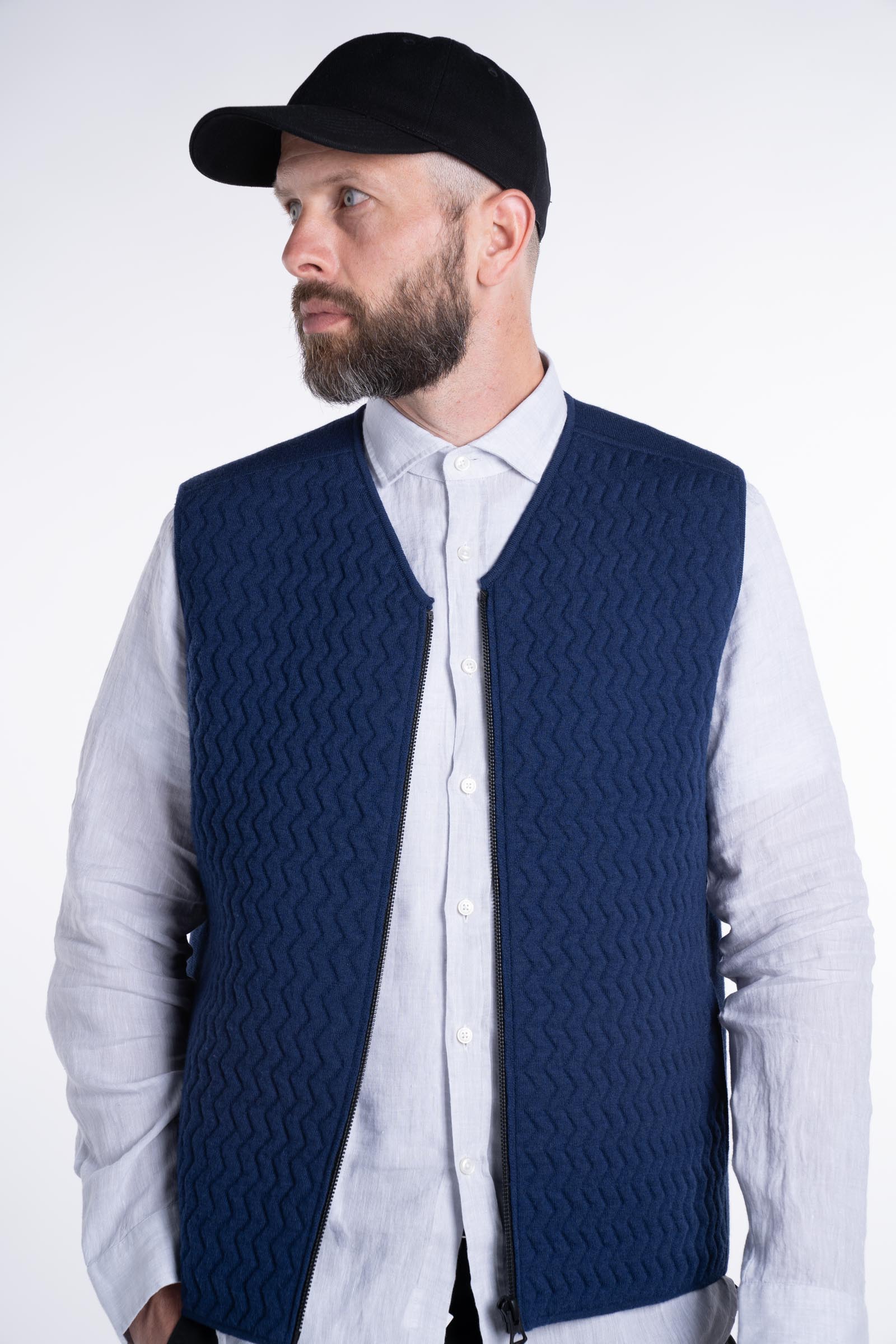Front view of model wearing the UNBORN Merino d&#39;Arles Padded vest in medieval blue with open zipper