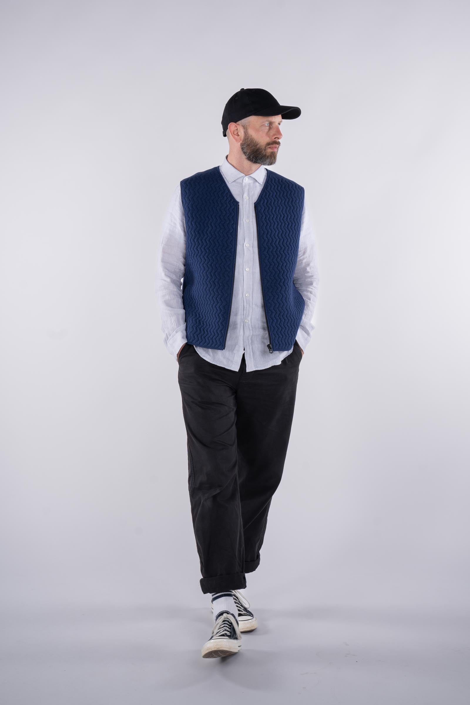 full frame view of model wearing the UNBORN Merino d&#39;Arles Padded vest in medieval blue with open zipper