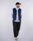 full frame view of model wearing the UNBORN Merino d'Arles Padded vest in medieval blue with open zipper