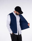 Front view of model wearing the UNBORN Merino d'Arles Padded vest in medieval blue showing pocket
