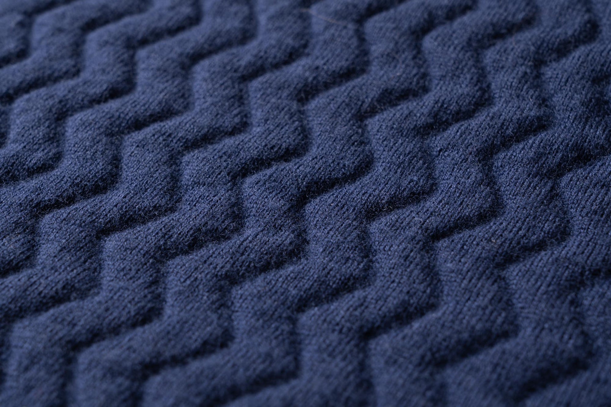A close-up of the textured wave knit structure of the Merino d'Arles padded vest.