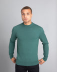 Model wearing The Merino Wool Sweater Light Foggy Green , front - Unborn