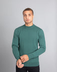 Model wearing The Merino Wool Sweater Light Foggy Green , front - Unborn