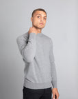 Model wearing The Merino Wool Sweater Light Grey Melange , front - Unborn