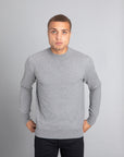 Model wearing The Merino Wool Sweater Light Grey Melange , front - Unborn
