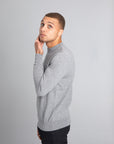 Model wearing The Merino Wool Sweater Light Grey Melange , left - Unborn