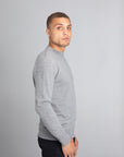 Model wearing The Merino Wool Sweater Light Grey Melange , right - Unborn