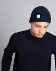 Model wearing The Merino wool beanie imperial blue, front view Unborn