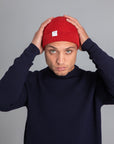 Model wearing The Merino wool beanie poppy red, front view Unborn