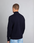 Model wearing the Merino wool Jacquard Button Up navy, back view Unborn
