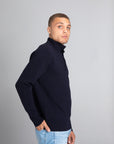 Model wearing the Merino wool Jacquard Button Up navy, right view Unborn