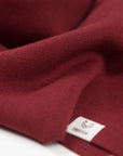 The Merino Wool Square Scarf Brick Red, close up fabric - Unborn