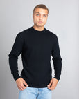 Model wearing The Merino Wool Sweater Black, front - Unborn