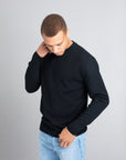 Model wearing The Merino Wool Sweater Black, front - Unborn