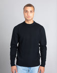 Model wearing The Merino Wool Sweater Black, front - Unborn