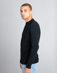 Model wearing The Merino Wool Sweater Black, left  - Unborn