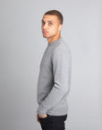 Model wearing The Merino Wool Sweater Grey Melange, left - Unborn