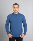 Model wearing The Merino Wool Sweater Sky Blue, front - Unborn