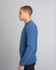 Model wearing The Merino Wool Sweater Sky Blue, left - Unborn